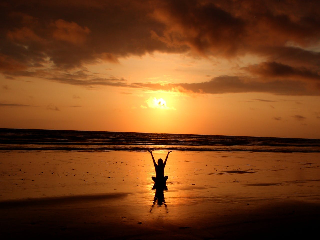 services-03 Peaceful meditation silhouette at sunset on a serene beach.